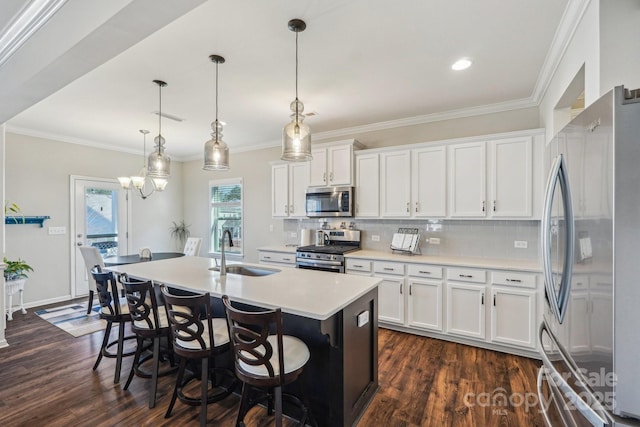 1426 Whitman Ct, York, SC 29745 - kitchen featuring stainless steel appliances, dark wood-style floors, a center island with sink, tasteful backsplash, and ornamental molding
