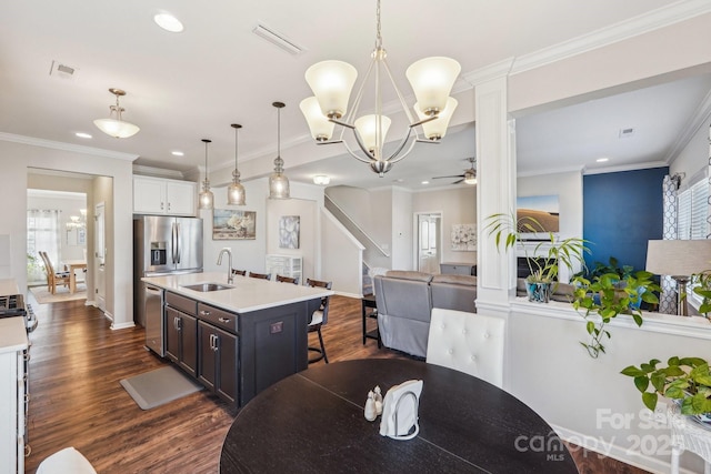 1426 Whitman Ct, York, SC 29745 - dining space with ceiling fan, dark wood-style floors, a chandelier, recessed lighting, and decorative columns