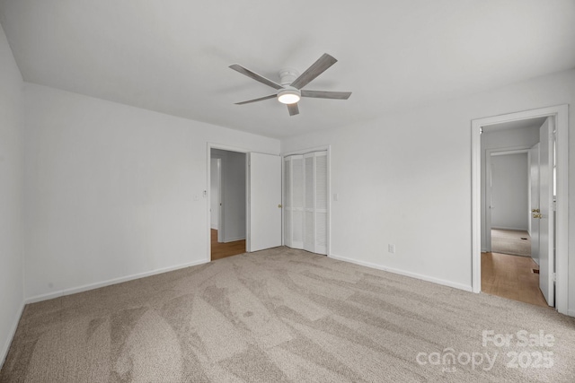 unfurnished bedroom featuring a ceiling fan, carpet flooring, and baseboards