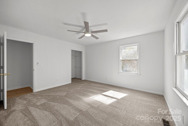 unfurnished bedroom with carpet floors, a closet, visible vents, and baseboards