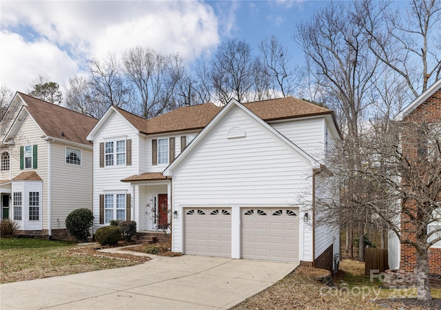 traditional-style home with a shingled roof, concrete driveway, and an attached garage