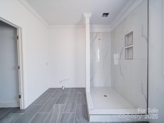 bathroom with a marble finish shower and ornamental molding