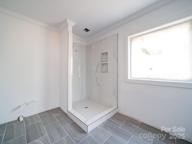 full bath with tile patterned flooring, a marble finish shower, and crown molding