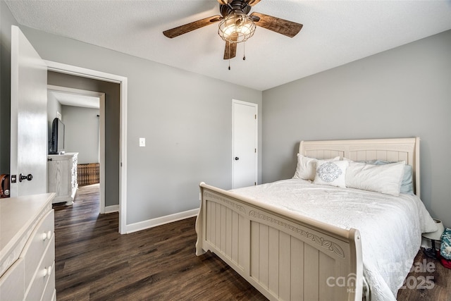 bedroom featuring dark wood-style floors, ceiling fan, a textured ceiling, and baseboards