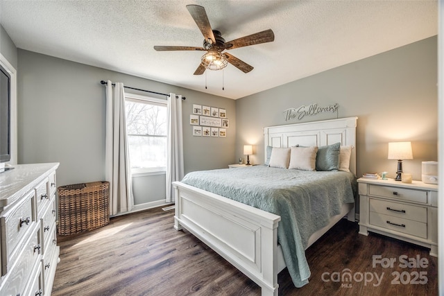 bedroom featuring ceiling fan, a textured ceiling, and dark wood-type flooring