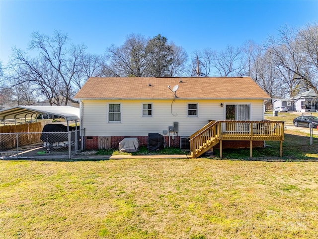 back of property featuring a lawn, stairs, fence, a deck, and a carport