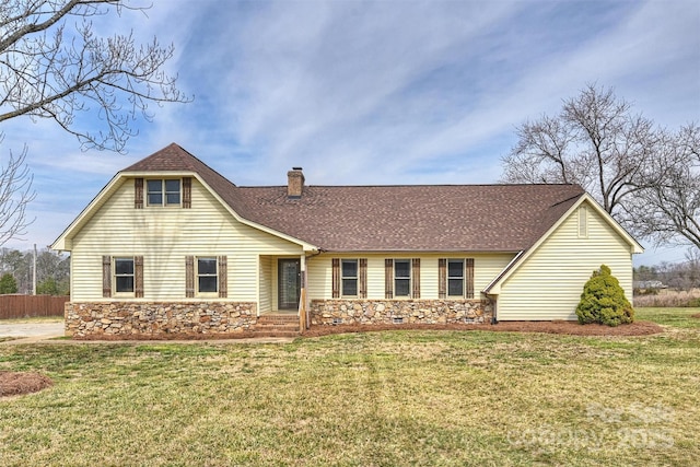 view of front of house with stone siding, a chimney, roof with shingles, fence, and a front lawn