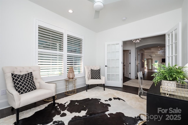 living area featuring arched walkways, french doors, recessed lighting, ceiling fan, and wood finished floors