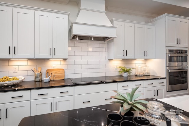 kitchen featuring crown molding, custom exhaust hood, backsplash, double oven, and black electric cooktop