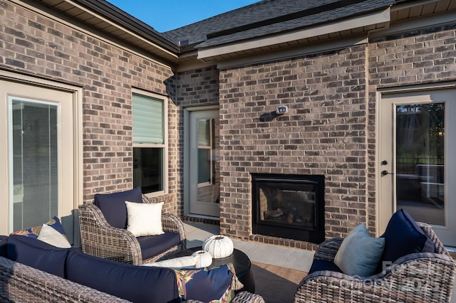 view of patio with an outdoor living space with a fireplace