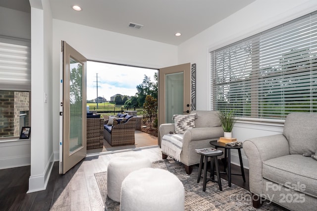 sitting room with baseboards, wood finished floors, visible vents, and recessed lighting