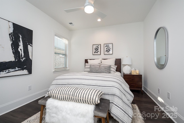 bedroom featuring wood finished floors, visible vents, and baseboards