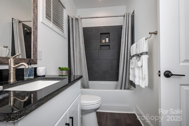 full bath featuring vanity, shower / bath combo, wood finished floors, and toilet