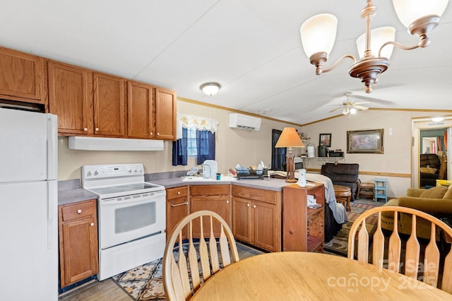 kitchen featuring lofted ceiling, a wall mounted AC, a peninsula, white appliances, and under cabinet range hood