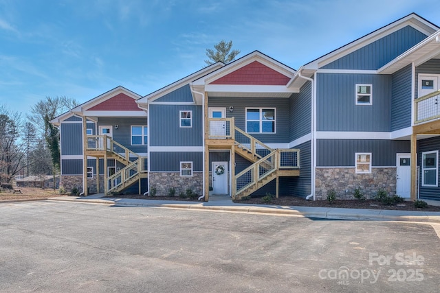 143 Carver St Unit 16, Brevard, NC 28712 - view of front of home with stairway, stone siding, and covered porch