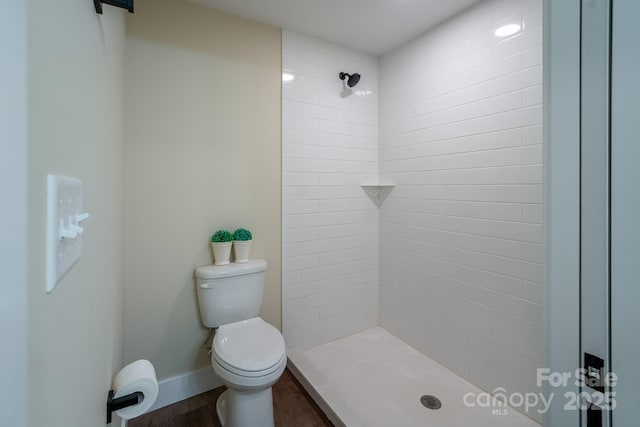 143 Carver St Unit 16, Brevard, NC 28712 - bathroom with toilet, tiled shower, wood finished floors, and baseboards