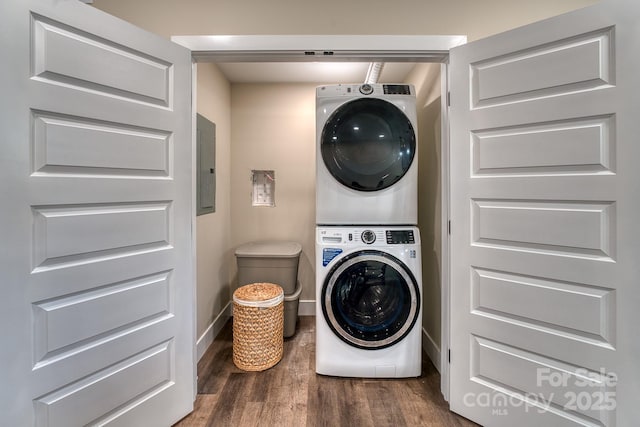 143 Carver St Unit 16, Brevard, NC 28712 - washroom featuring estacked washer and dryer, wood finished floors, electric panel, and baseboards