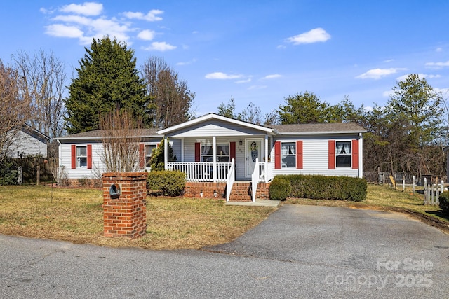 view of front of property with a front yard and covered porch