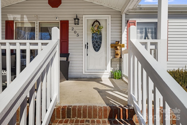 view of exterior entry featuring covered porch