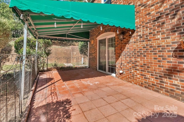 view of patio featuring fence