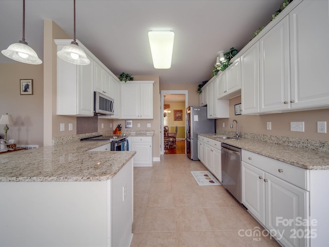 kitchen with light tile patterned floors, a peninsula, a sink, white cabinetry, and appliances with stainless steel finishes