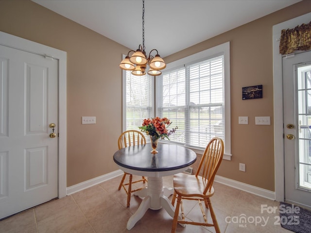 dining area with light tile patterned floors, baseboards, and an inviting chandelier