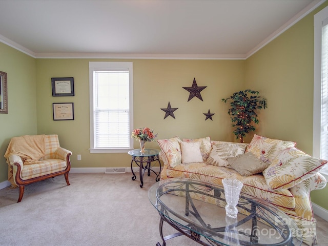 living room featuring baseboards, visible vents, crown molding, and carpet flooring