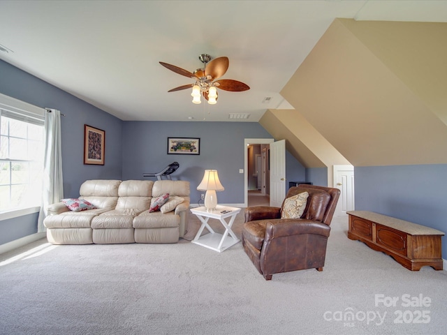 carpeted living room featuring ceiling fan, vaulted ceiling, and visible vents