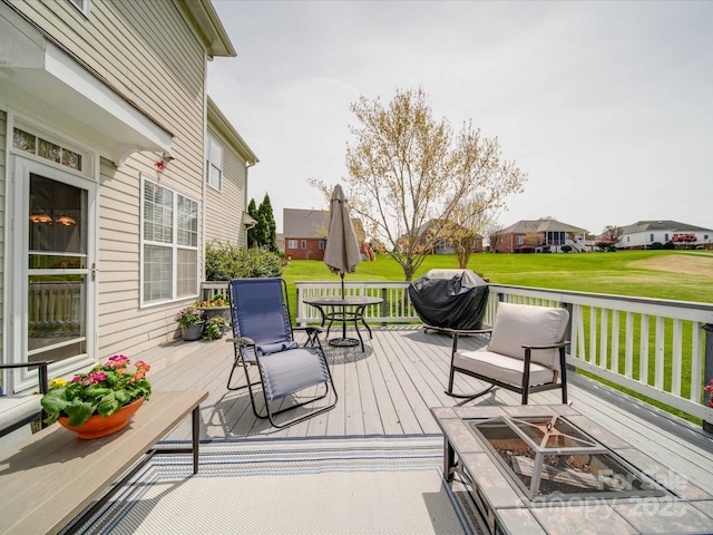 wooden terrace featuring a lawn and a residential view