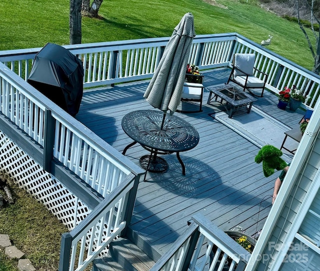 wooden terrace with stairway and a lawn