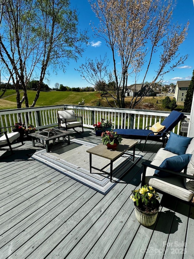 wooden terrace featuring an outdoor living space