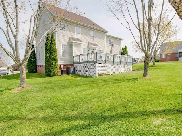 back of house with crawl space, a yard, a wooden deck, and central AC unit