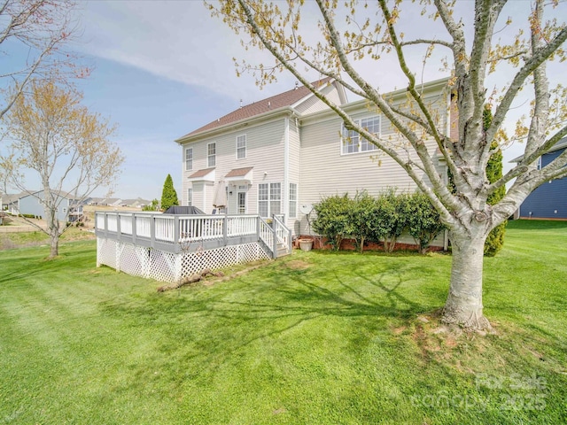 back of house with a deck and a lawn