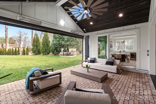 view of patio / terrace with ceiling fan and an outdoor living space