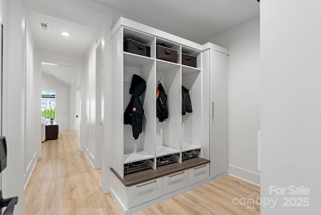 mudroom with light wood-style flooring, visible vents, and baseboards