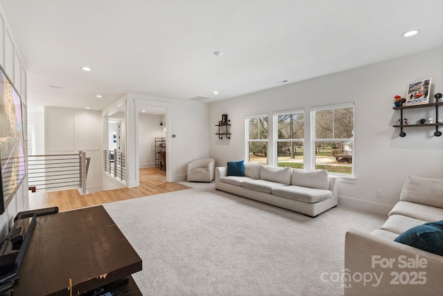 living room with light wood-type flooring, baseboards, and recessed lighting