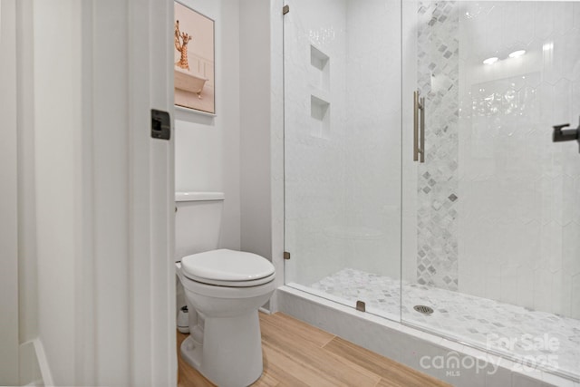 16112 Terry Ln, Huntersville, NC 28078 - bathroom featuring wood finished floors, toilet, and a stall shower