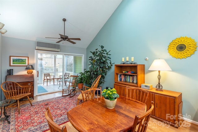 dining area with ceiling fan, high vaulted ceiling, wood finished floors, and a wall mounted AC