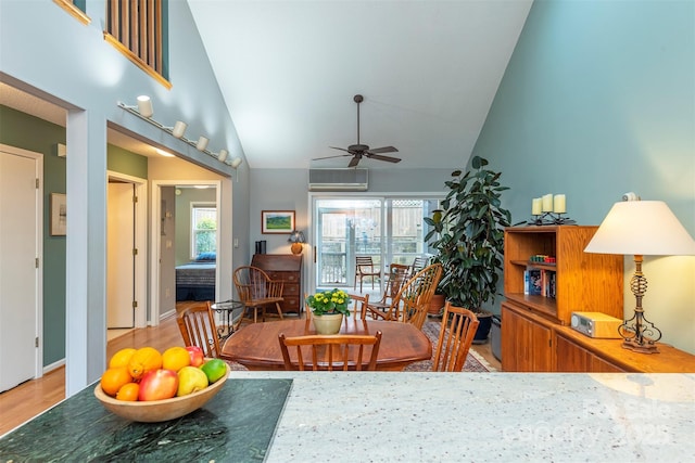 dining room featuring plenty of natural light, high vaulted ceiling, ceiling fan, and a wall unit AC