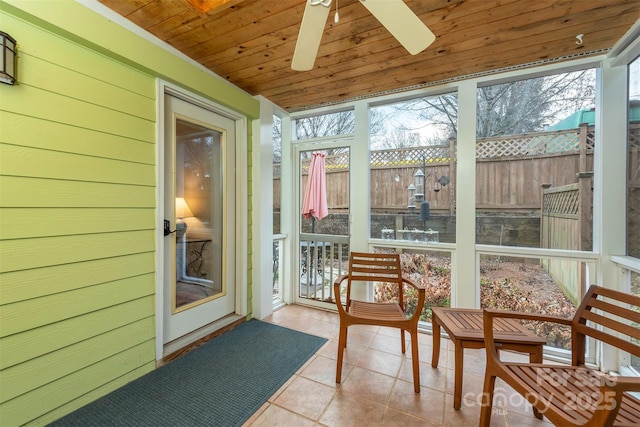 sunroom / solarium with wooden ceiling and a ceiling fan