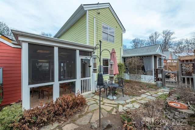 back of house featuring a sunroom