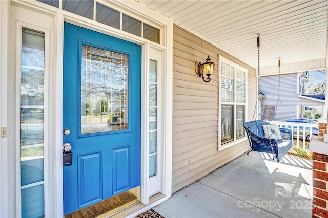 view of exterior entry with a porch