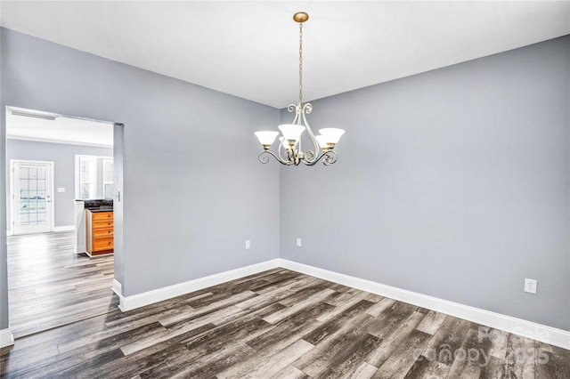 spare room featuring visible vents, dark wood-style floors, and baseboards