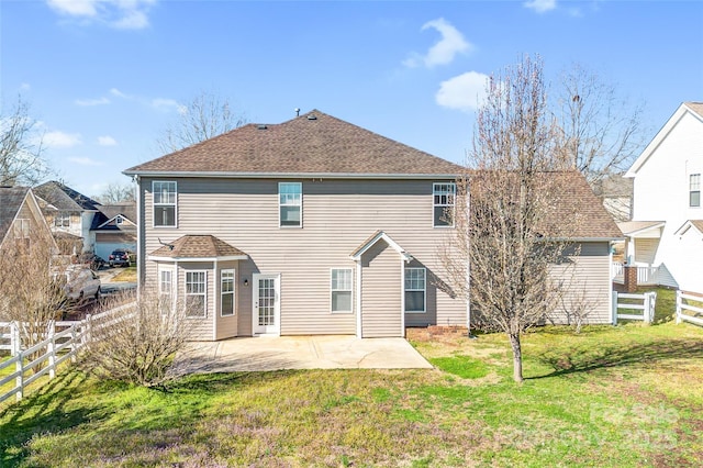 back of house featuring a yard, a patio, roof with shingles, and a fenced backyard