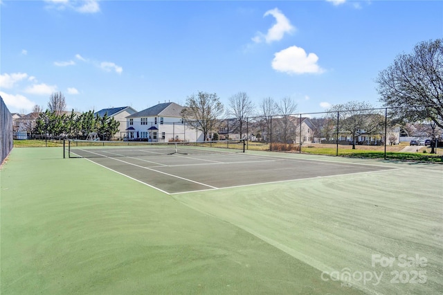 view of sport court featuring a residential view and fence