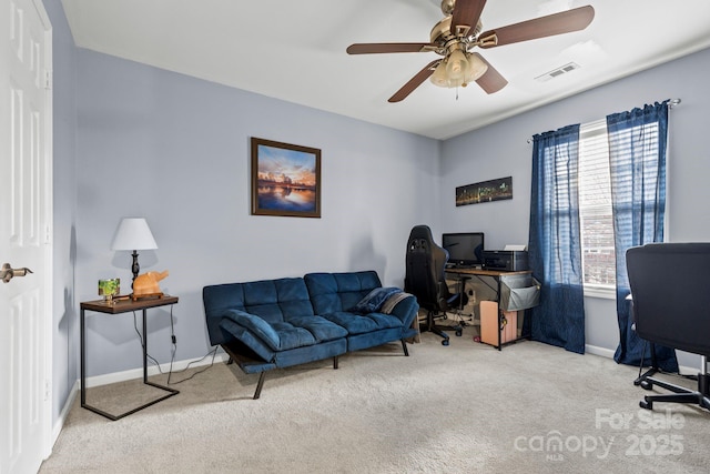 office space featuring carpet floors, plenty of natural light, visible vents, and baseboards