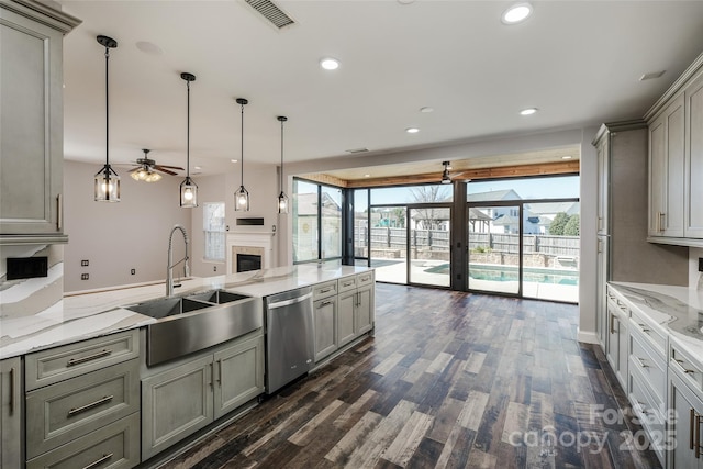 kitchen featuring dark wood-type flooring, a sink, visible vents, stainless steel dishwasher, and gray cabinets