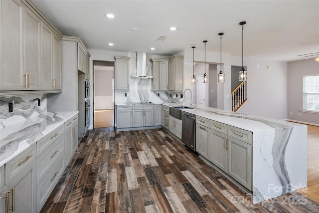 kitchen featuring stainless steel dishwasher, gray cabinetry, a peninsula, and wall chimney exhaust hood