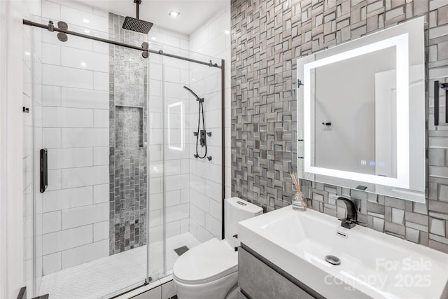 full bathroom featuring tasteful backsplash, toilet, vanity, a shower stall, and tile walls