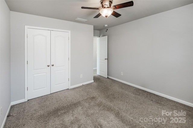 unfurnished bedroom with ceiling fan, carpet flooring, visible vents, baseboards, and a closet